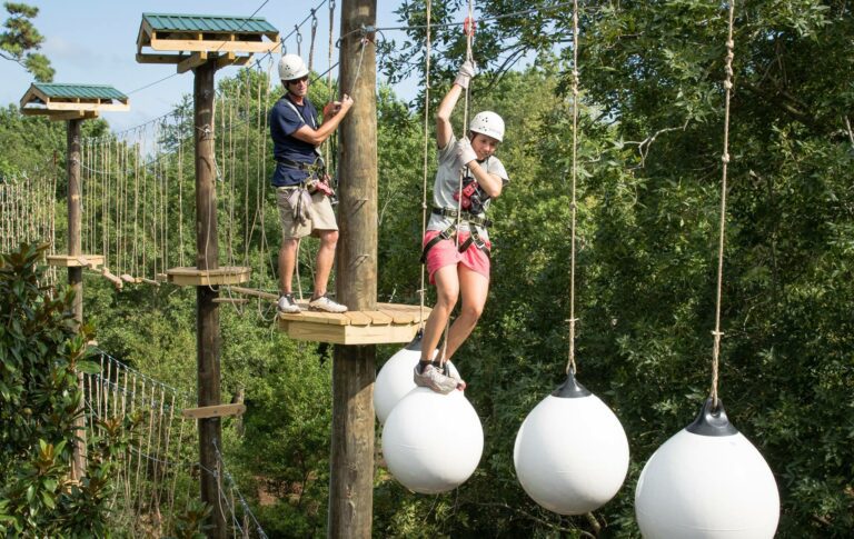 People Walking Across Ropes Course